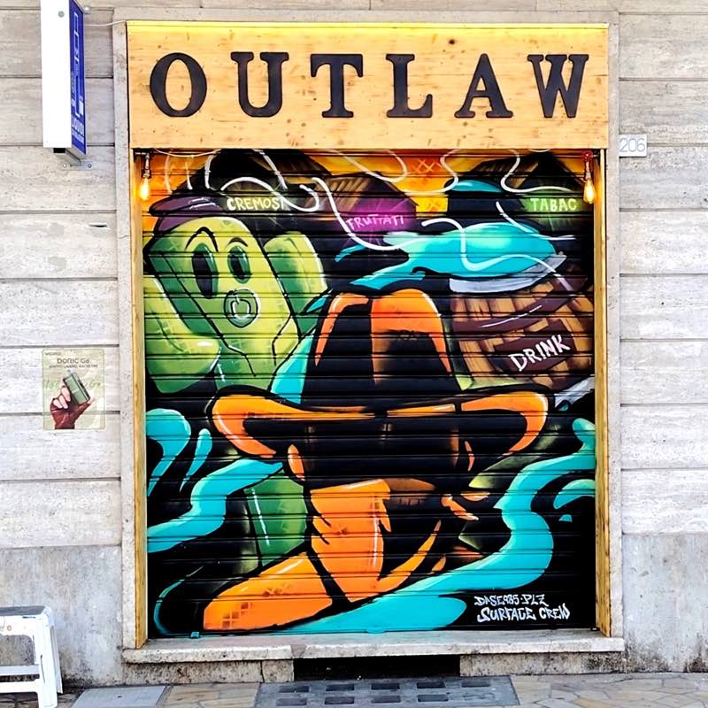 OUTLAW, negozio di sigarette elettroniche e drink. Spray paint sulla serranda