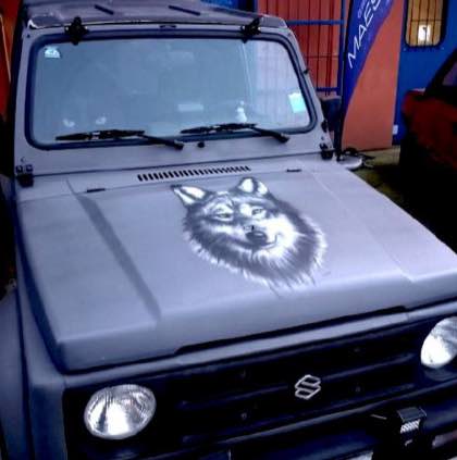 Cofano di una Suzuki Samurai, aerografato con il viso di un lupo